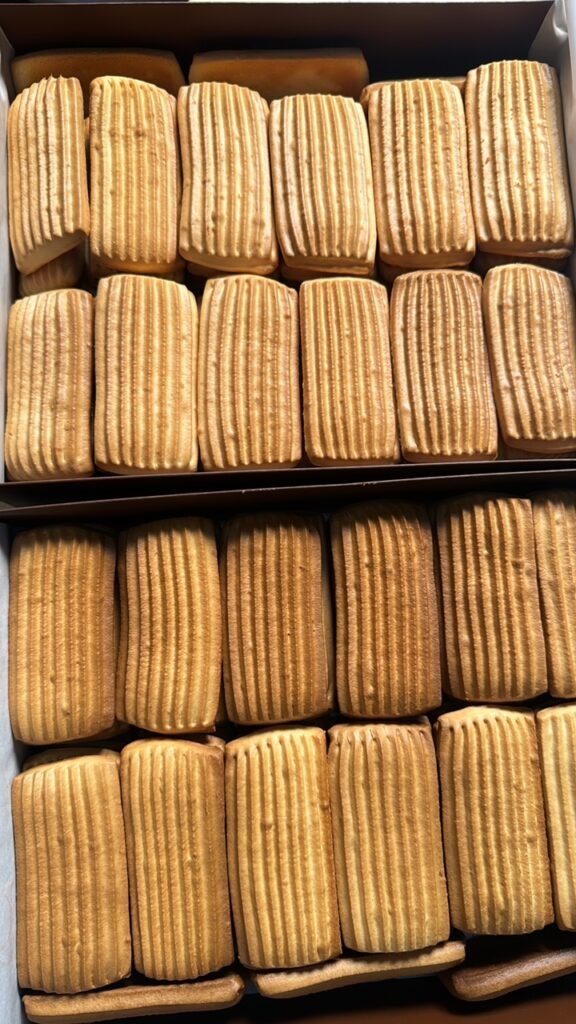 A box of freshly baked traditional biscuits by Hala Cookies, with a classic ridged texture, perfect for tea time and family gatherings in Doha.